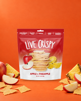 Live Crispy Apple + Pineapple bag with apple chips and apple slices on orange