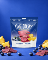Live Crispy Blueberry + Pineapple bag with blueberry chips and fresh blueberries on blue
